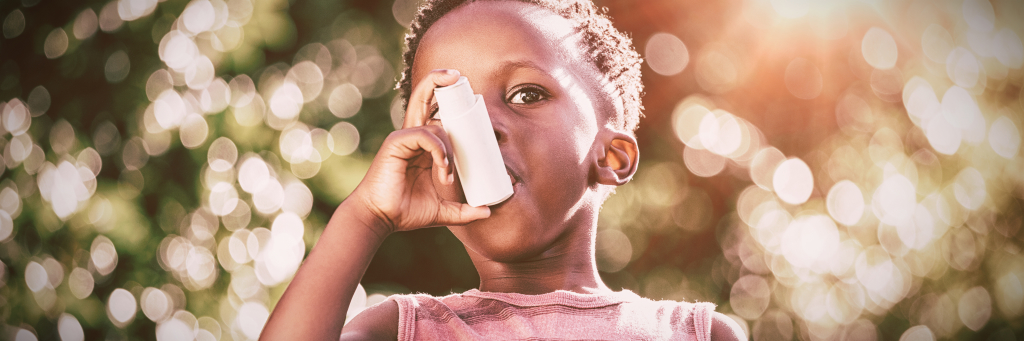 boy with asthma using inhaler